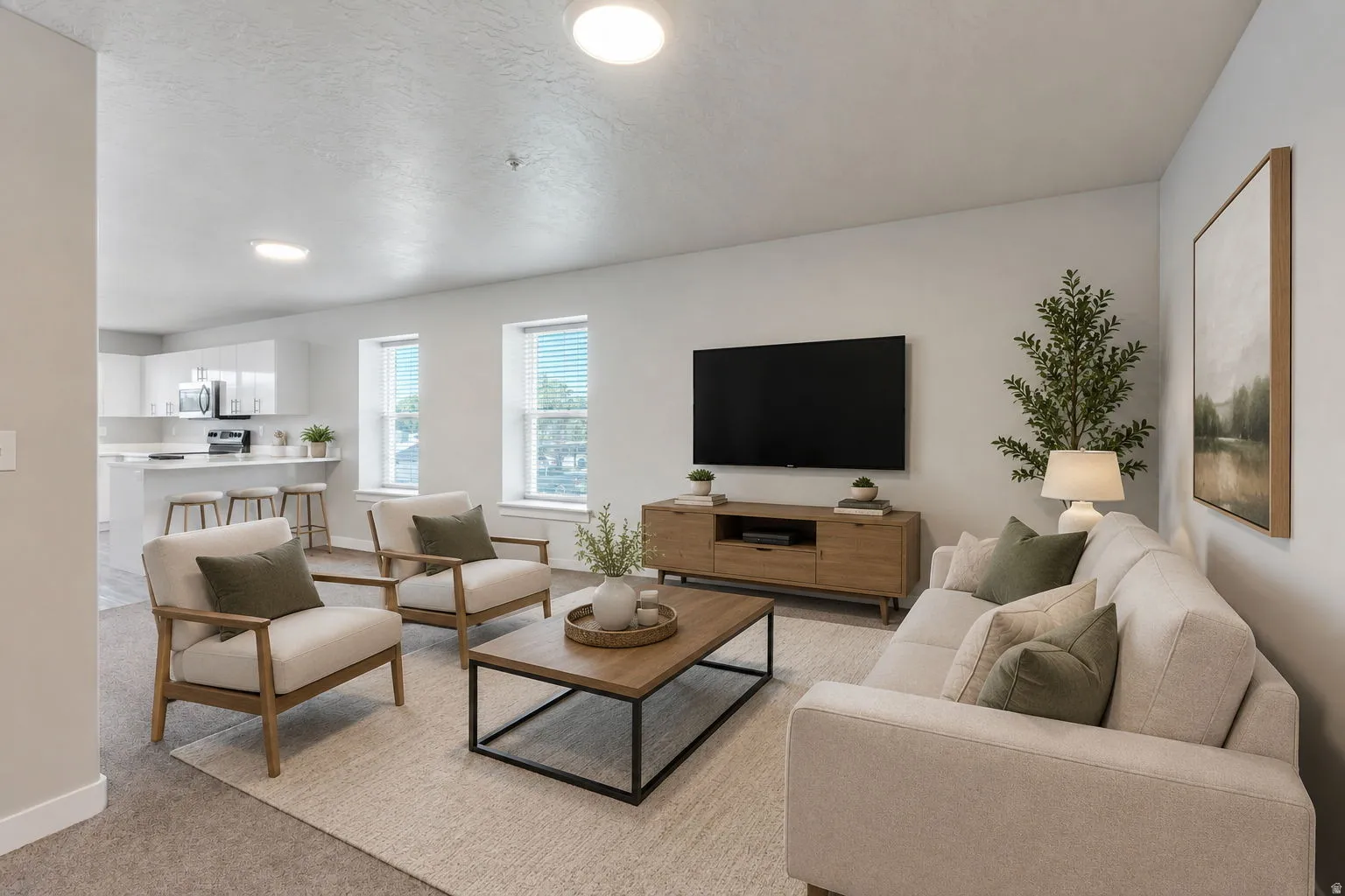 Open-concept living space featuring recessed lighting, multiple windows, and a kitchen with a breakfast bar and stainless steel appliances