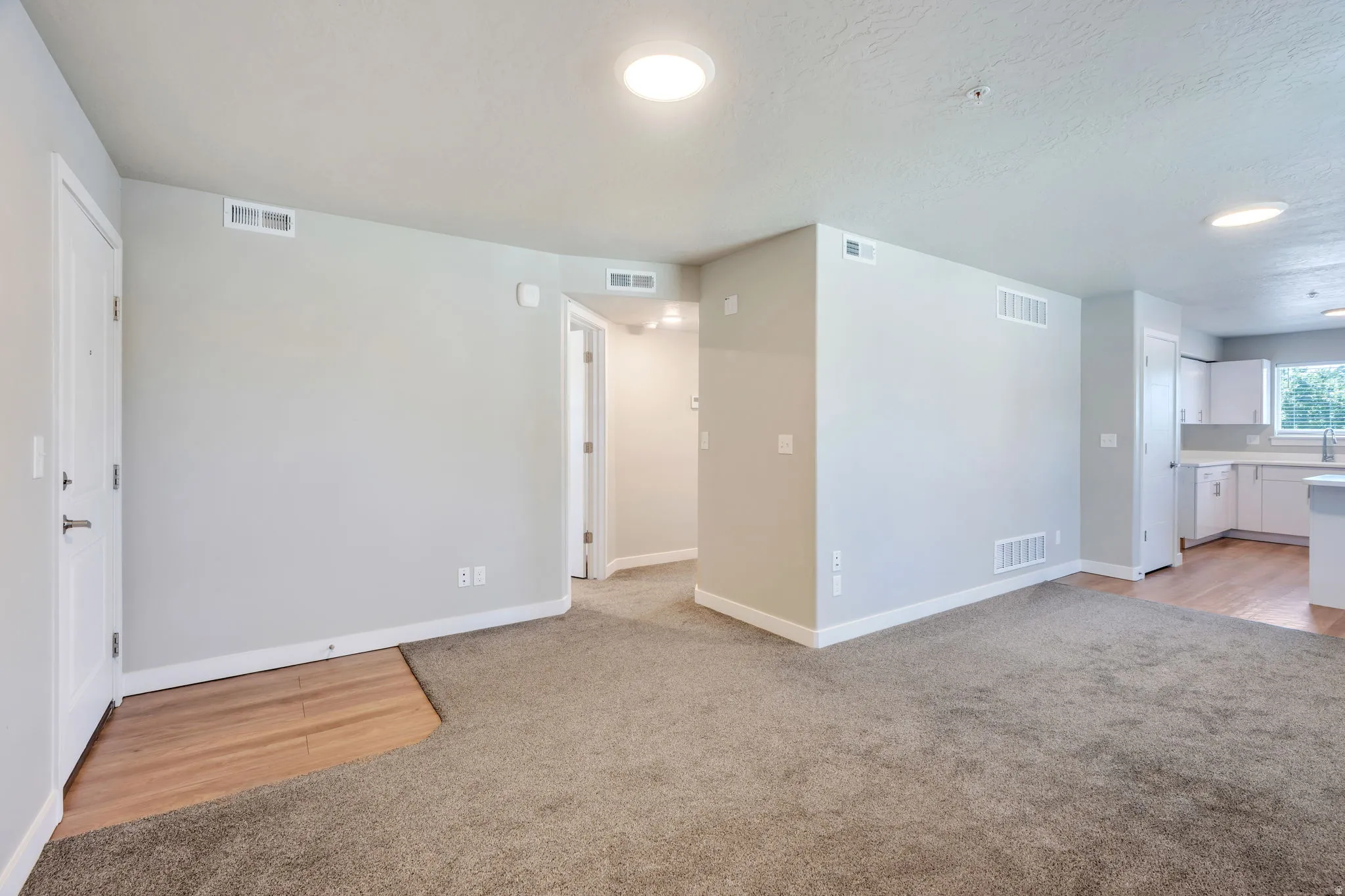 Open living area with grey-toned walls and recessed lighting
