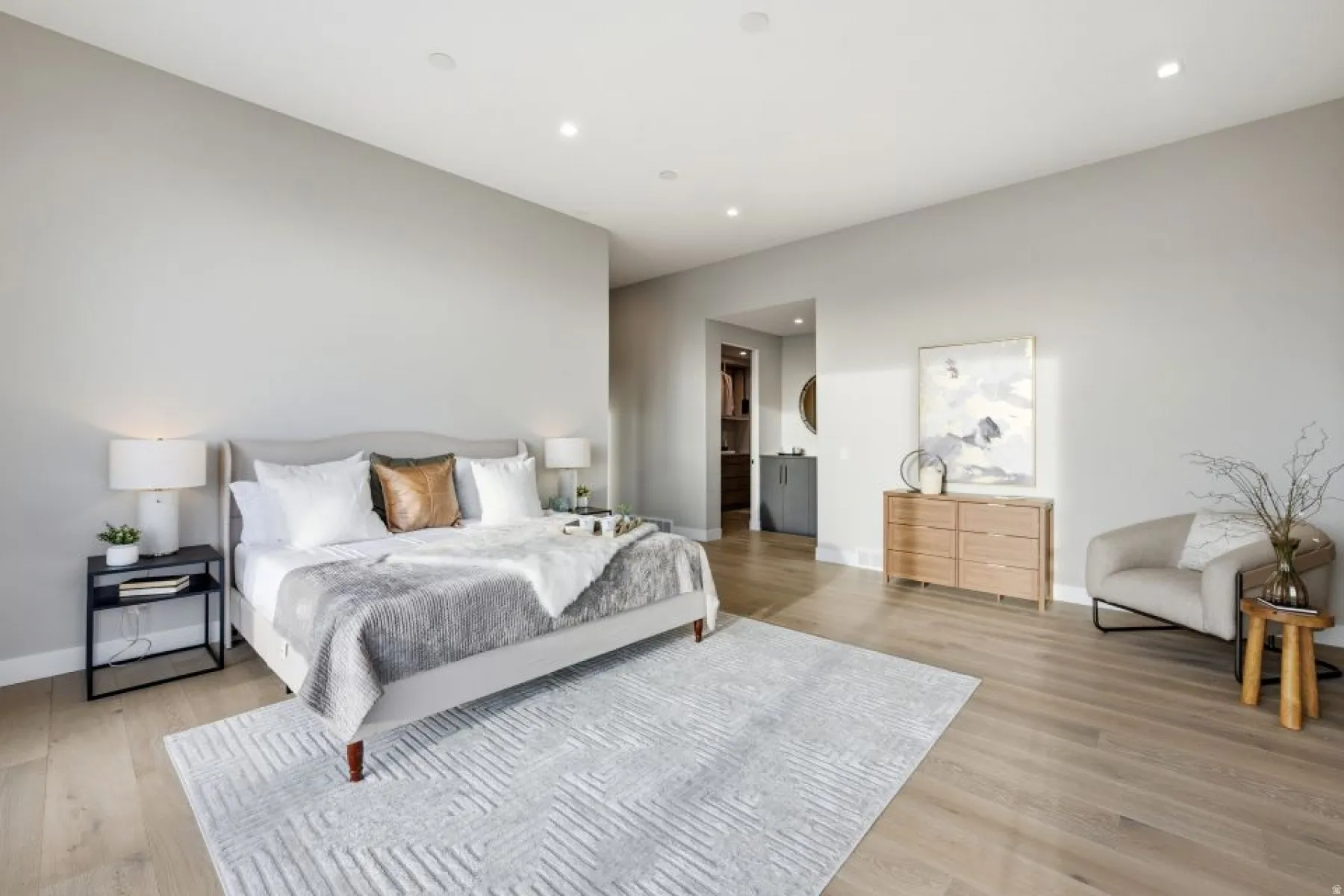 Light wood-finish flooring provides a bright foundation in this spacious room