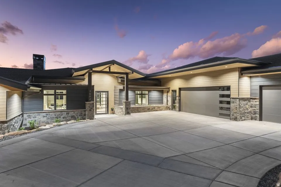 Contemporary exterior featuring stone accents, horizontal siding, and a prominent covered entry
