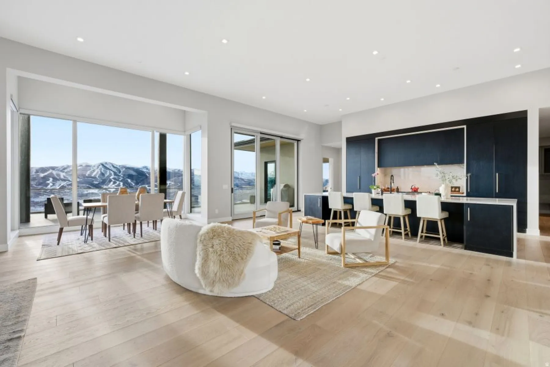 Open-concept living space featuring wood-finish flooring and recessed lighting