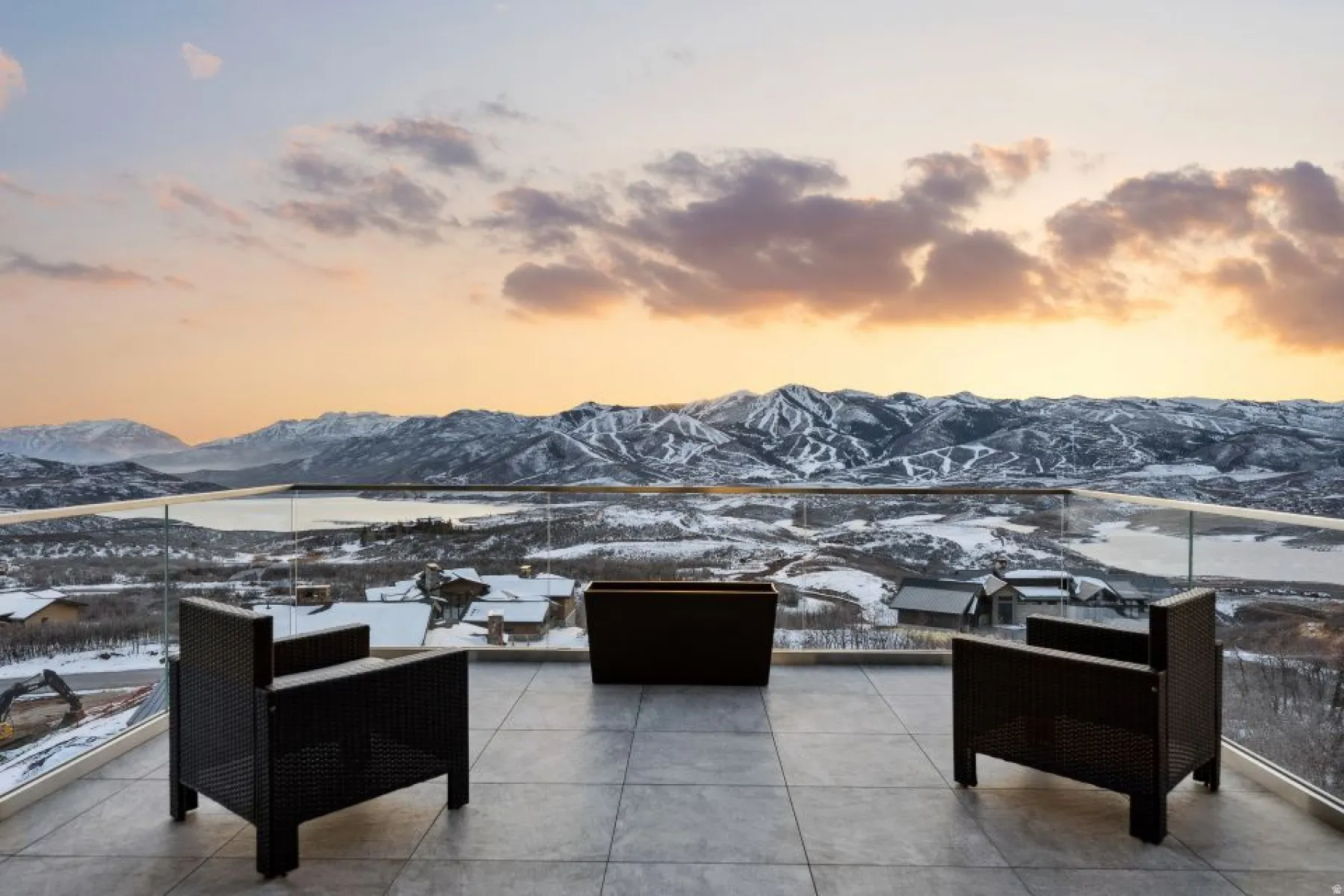 Expansive outdoor terrace featuring large format tile flooring and a glass railing system