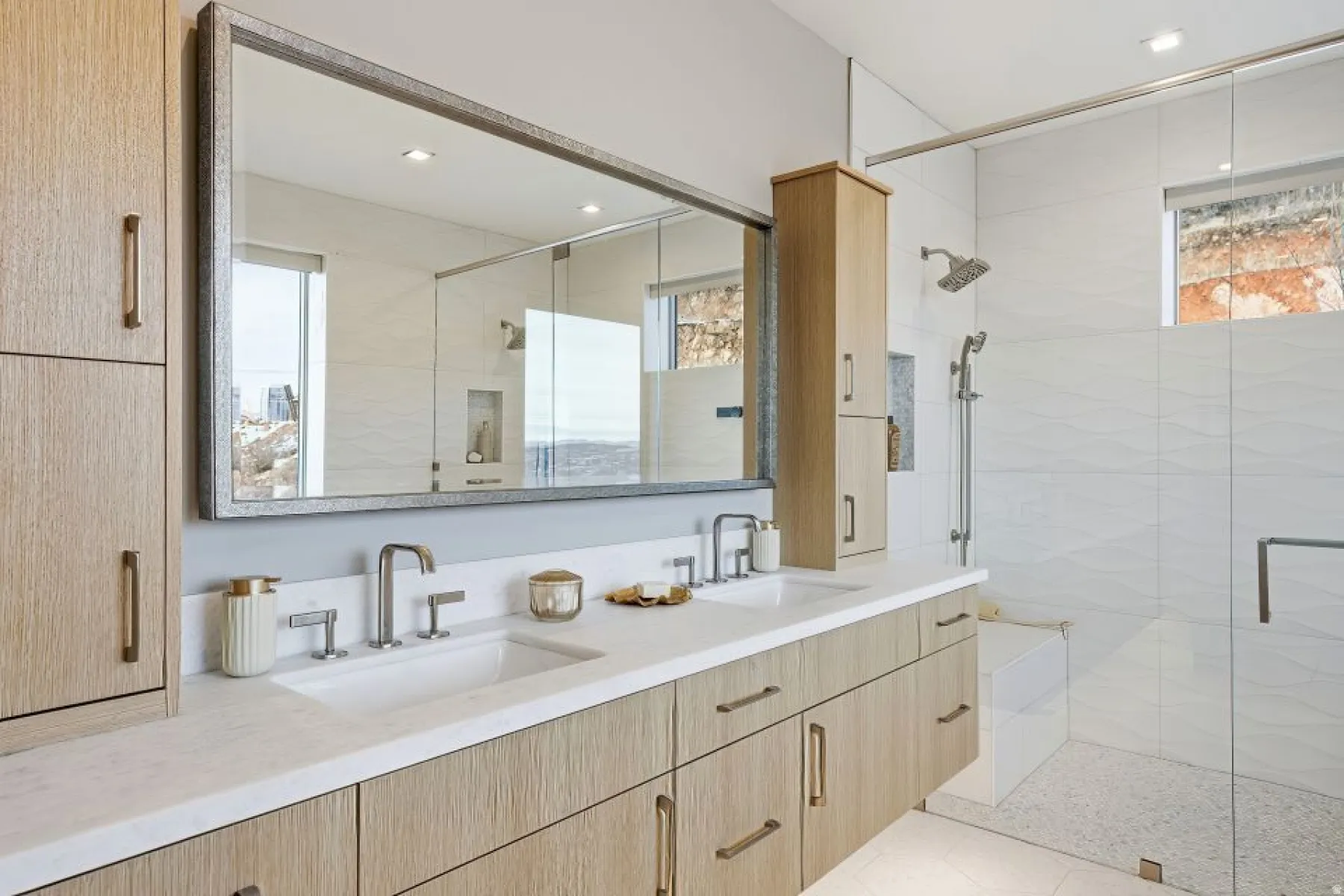 Dual vanity with undermount sinks, stone countertop, and contemporary faucets