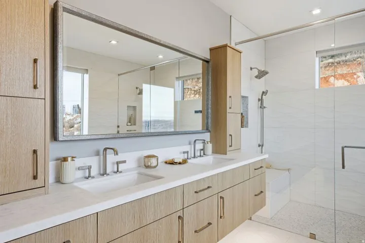 Dual vanity with undermount sinks, stone countertop, and contemporary faucets