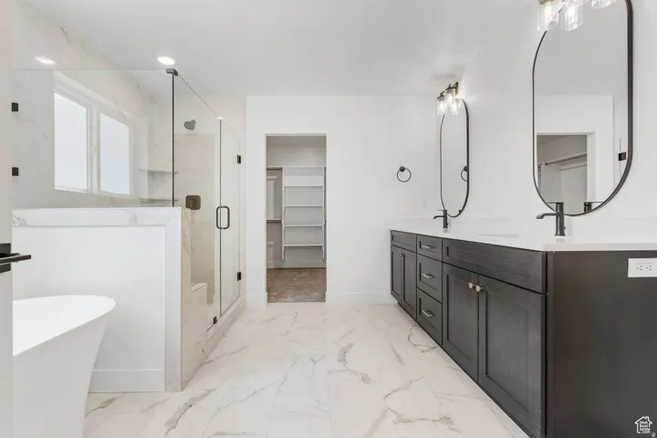 Spacious bathroom featuring a dual vanity with dark wood-finish cabinetry, white countertops, and matte black fixtures