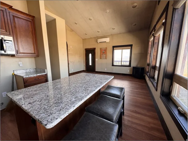 Spacious open-concept interior featuring a substantial island with a light-toned patterned countertop