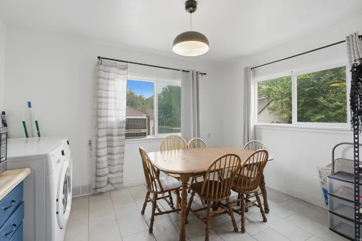 Bright dining area featuring light-toned tile flooring and white walls