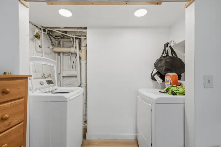 Dedicated laundry area featuring a top-load washing machine and a front-load dryer