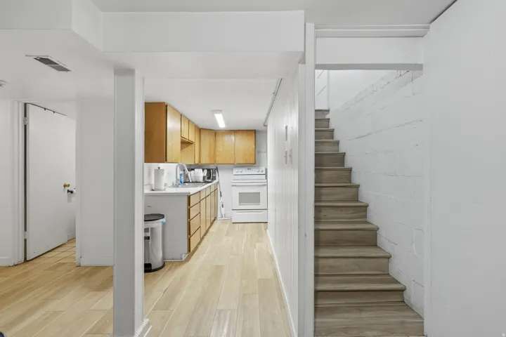Kitchen, entry to family room and stairs to exit