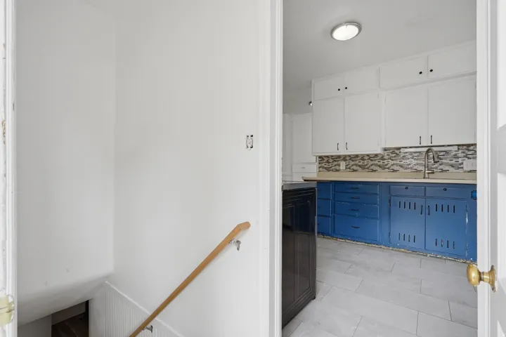 Kitchen and downstairs leading to basement