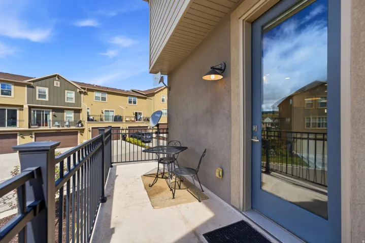 Outdoor patio featuring a concrete surface and black metal railing