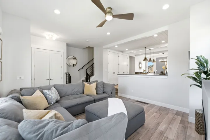 Open concept living area featuring wood-finish flooring, recessed lighting, and a ceiling fan