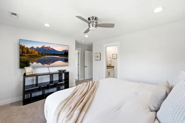 Carpeted bedroom featuring recessed lighting, a modern ceiling fan, and a neutral color palette