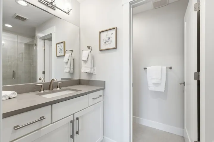 Contemporary bathroom vanity featuring a rectangular undermount sink, a gray countertop, and brushed nickel fixtures