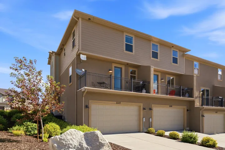Multi-level townhome featuring a stucco and siding exterior