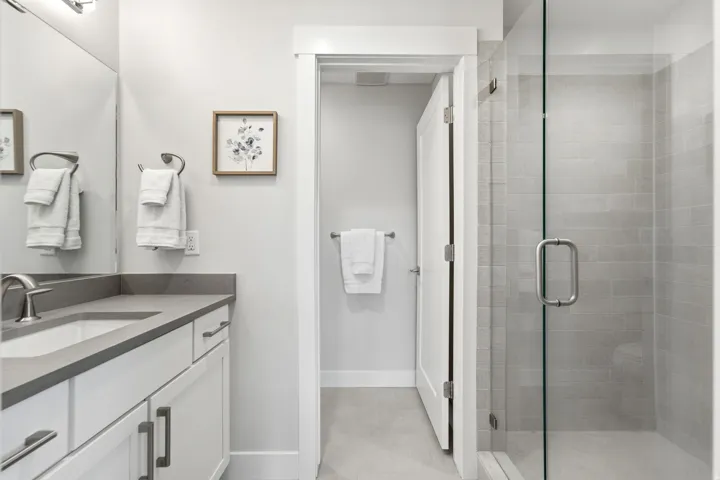Full bathroom featuring a white vanity with gray countertop, undermount sink, and brushed nickel faucet