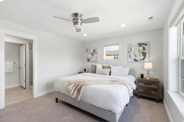 Carpeted bedroom with a ceiling fan, recessed lighting, and an entryway to a full bathroom