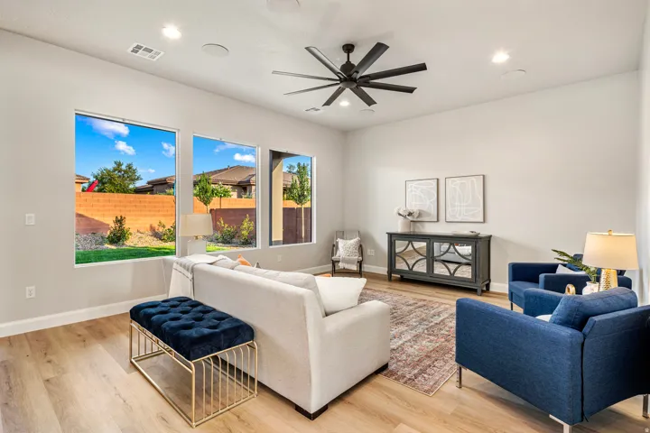 Living area featuring wood-finish flooring, recessed lighting, and a modern ceiling fan