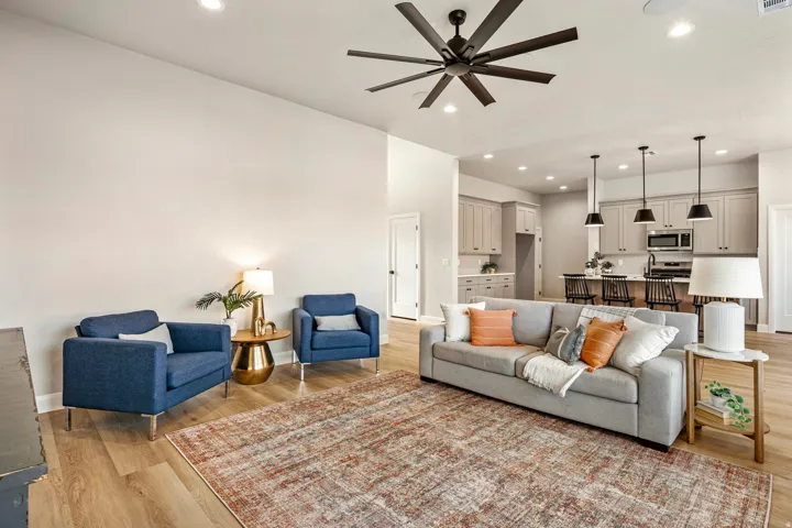 Open-concept living space featuring wood-finish flooring, recessed lighting, and a modern ceiling fan