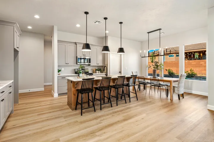 Open-concept kitchen and dining area featuring light wood-finish flooring