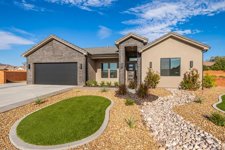 Contemporary stucco and brick facade with a prominent front entry