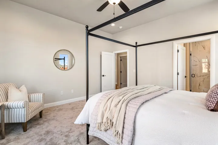 Bedroom featuring carpet flooring, tray ceiling, recessed lighting, and a ceiling fan