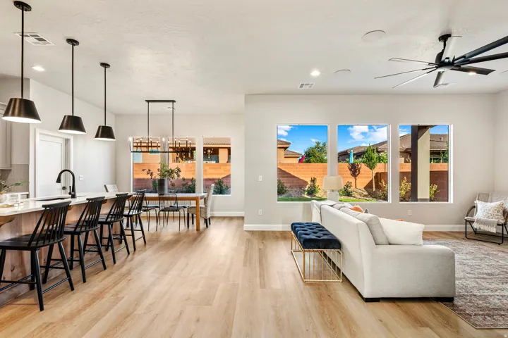 Open-concept living space featuring wood-finish flooring, recessed lighting, and a contemporary ceiling fan