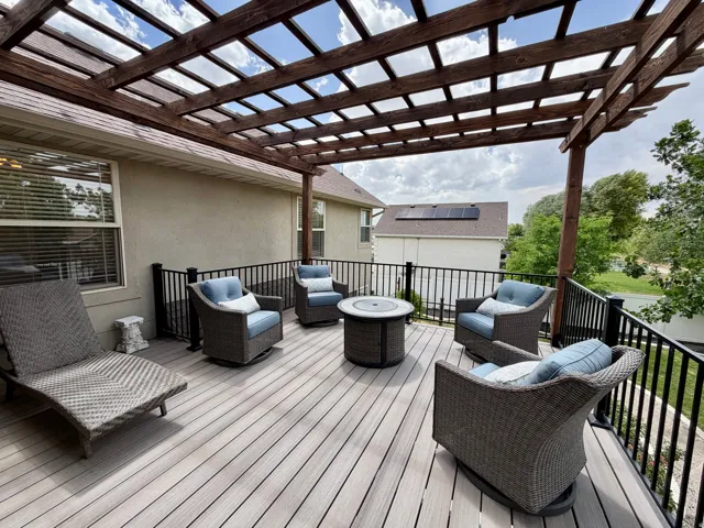 Expansive outdoor deck featuring wood-finish composite decking and an overhead wood pergola