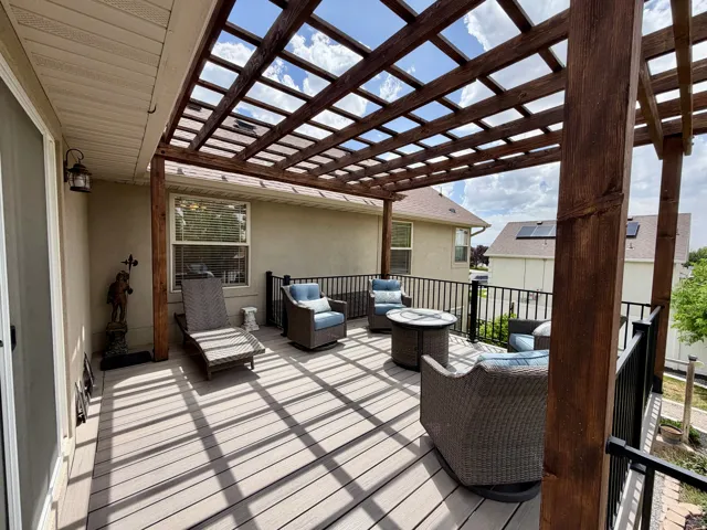 Expansive deck with a slatted pergola structure