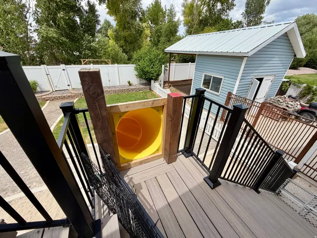 Multi-level outdoor decking featuring composite wood-finish boards and black metal railings