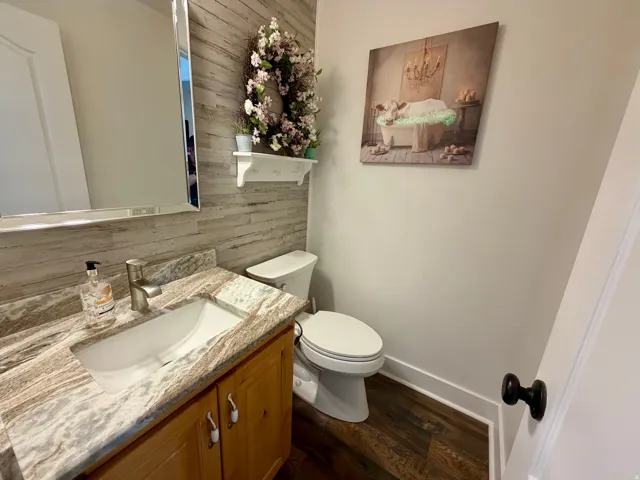Bathroom featuring a wood-finish plank accent wall