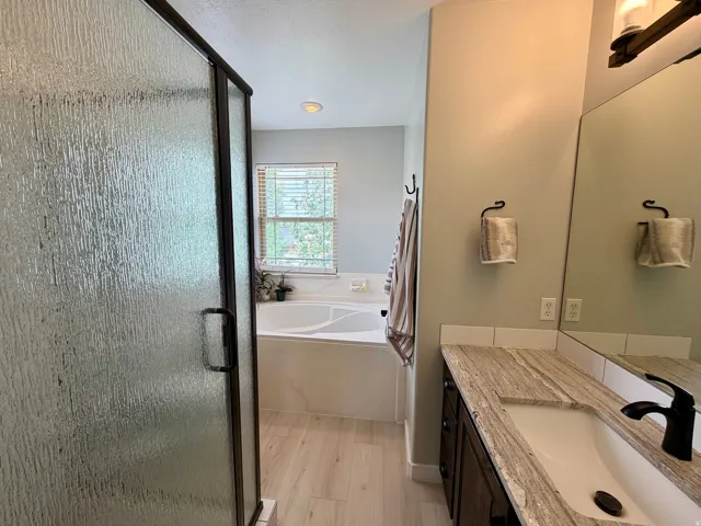 Walk-in shower with textured glass enclosure