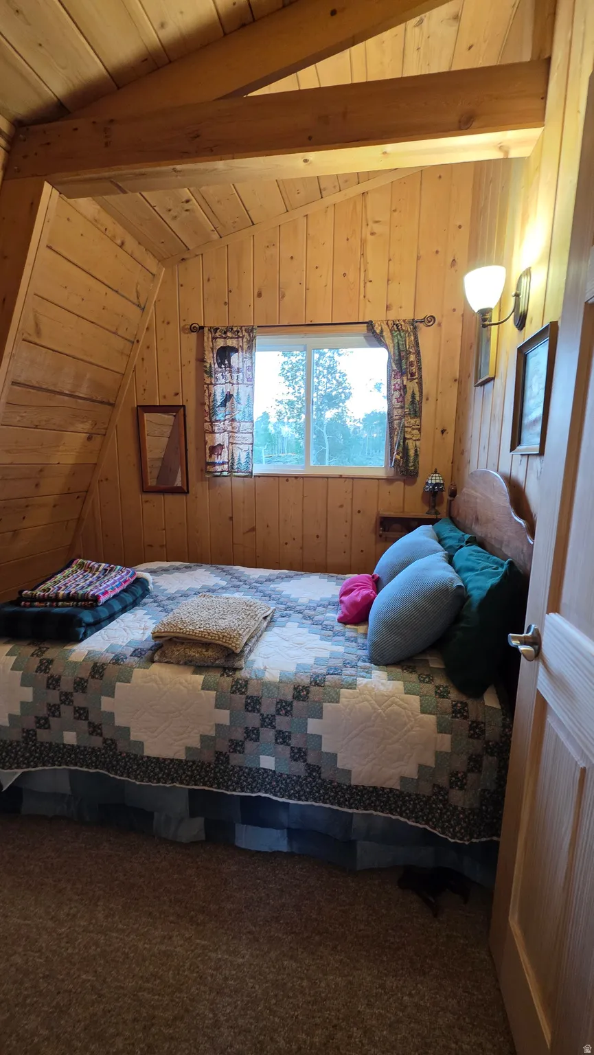 A-frame interior featuring natural wood plank walls and ceilings
