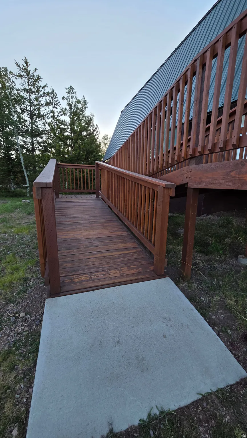 Stained wood deck with a ramp entry and slatted railings