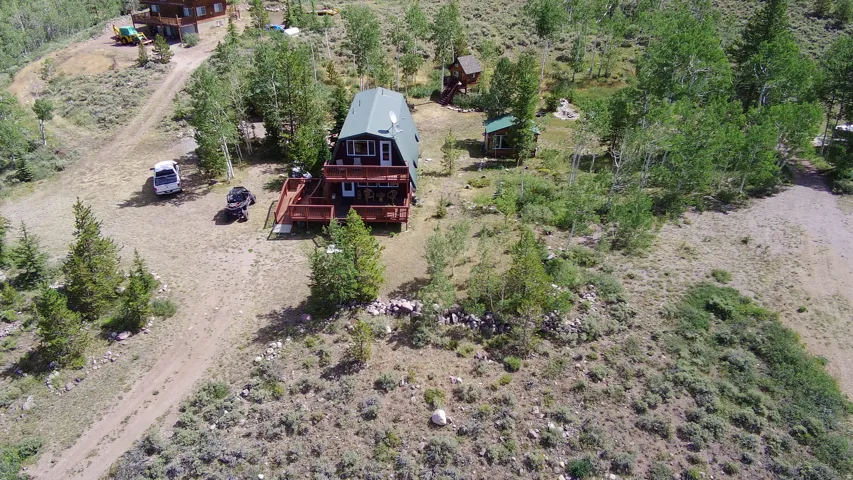 A-frame property featuring a green roof, two-story exterior deck, and multiple windows