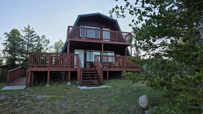Two-story barn-style residence featuring a dark wood-finish exterior
