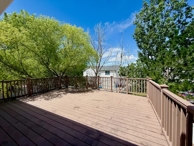 Spacious exterior deck featuring wood-finish flooring and a full perimeter railing