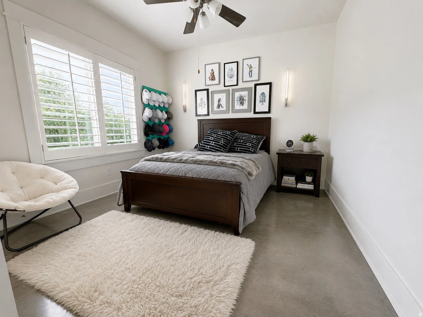 Spacious room featuring concrete flooring and white baseboards