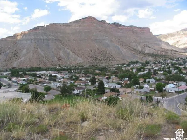Expansive desert mountain backdrop with a residential area below