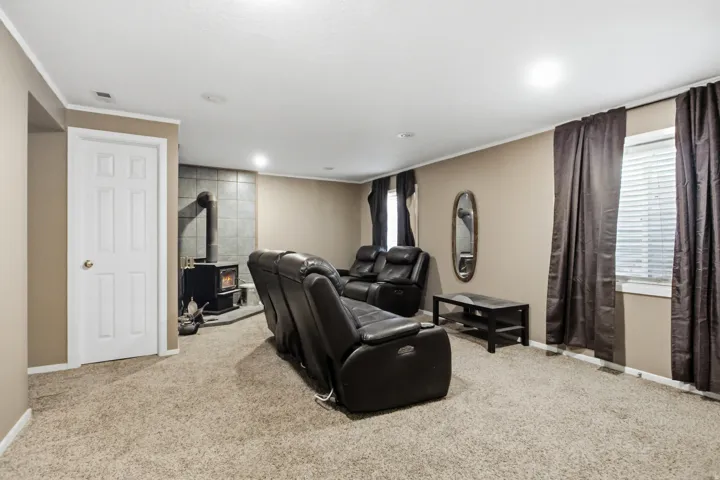 Inviting living space featuring plush carpeting, warm neutral wall tones, and recessed lighting