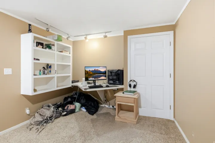 Interior room featuring neutral wall paint and light-colored carpeting