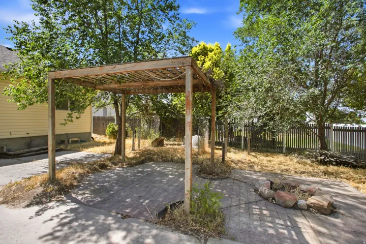 Patio area featuring a wood pergola and paver flooring