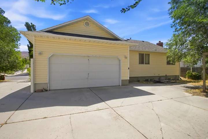 Attached two-car garage with a concrete driveway