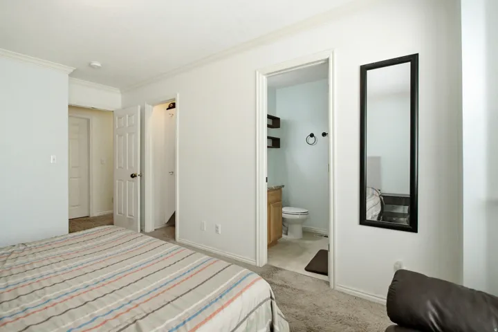 Bedroom space with carpet flooring and light-toned walls