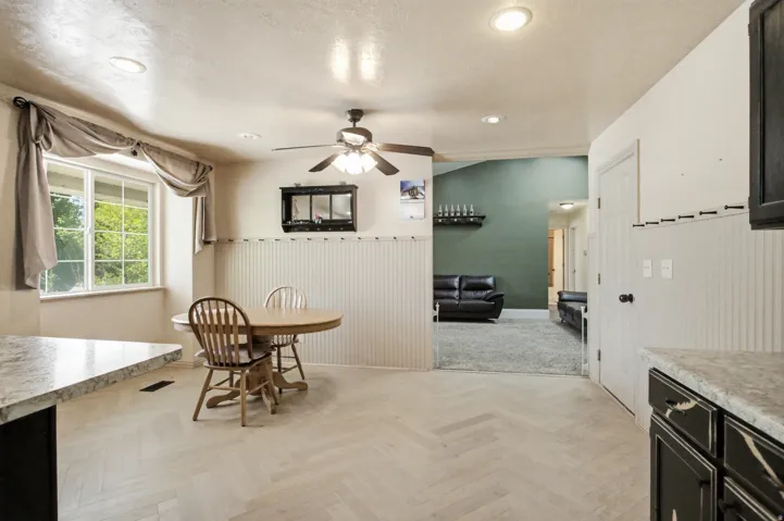 Spacious kitchen and dining area with wood-finish herringbone flooring