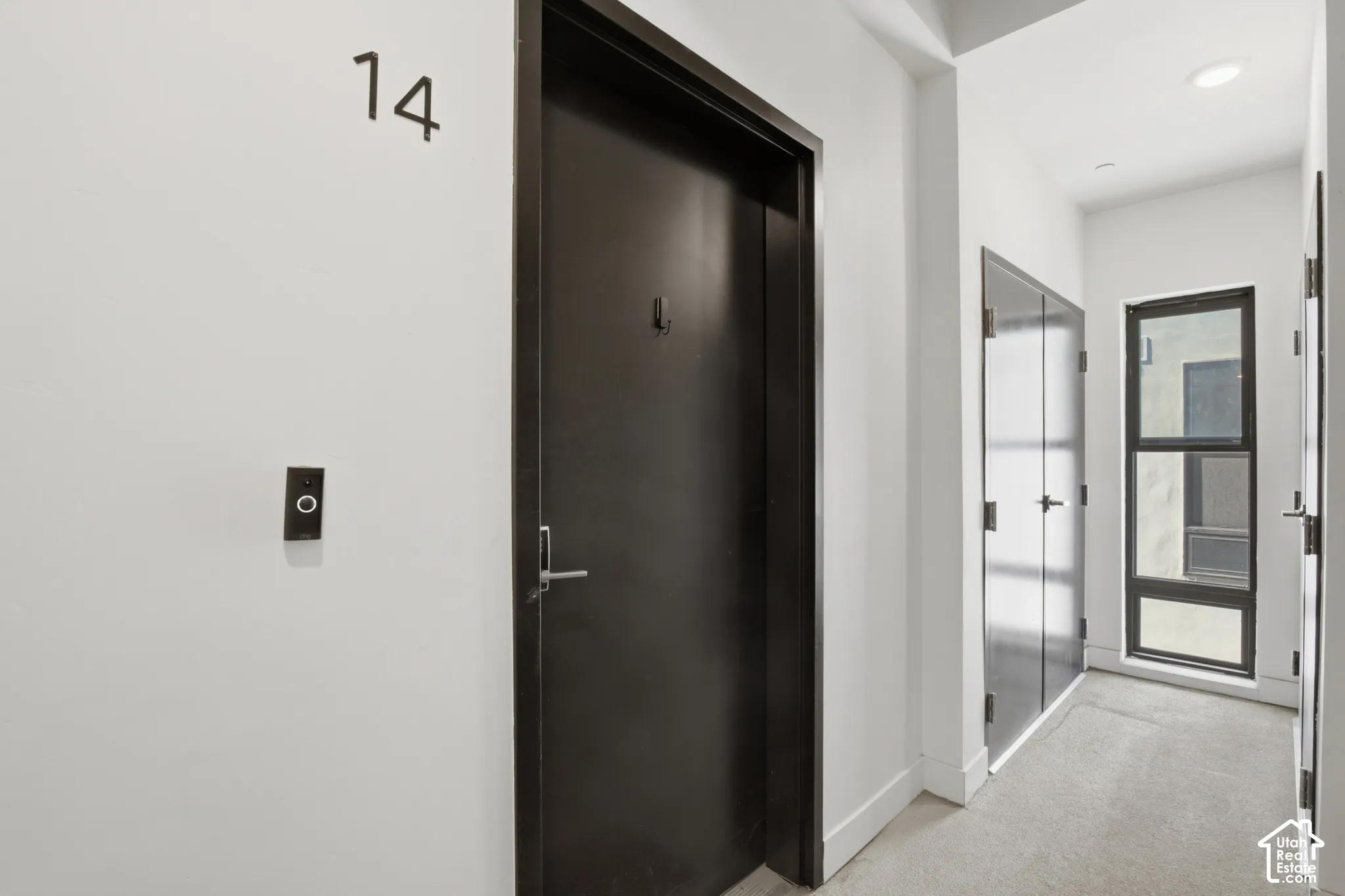 Front door to the condo and access to the mechanical room - we love a hallway window letting in natural light!