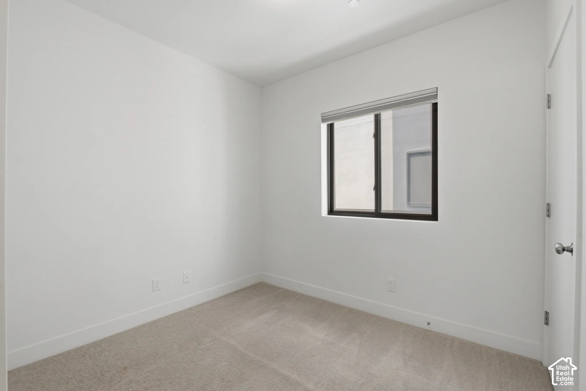 Bedroom on the main level featuring a sliding barn door - also makes a great office space!