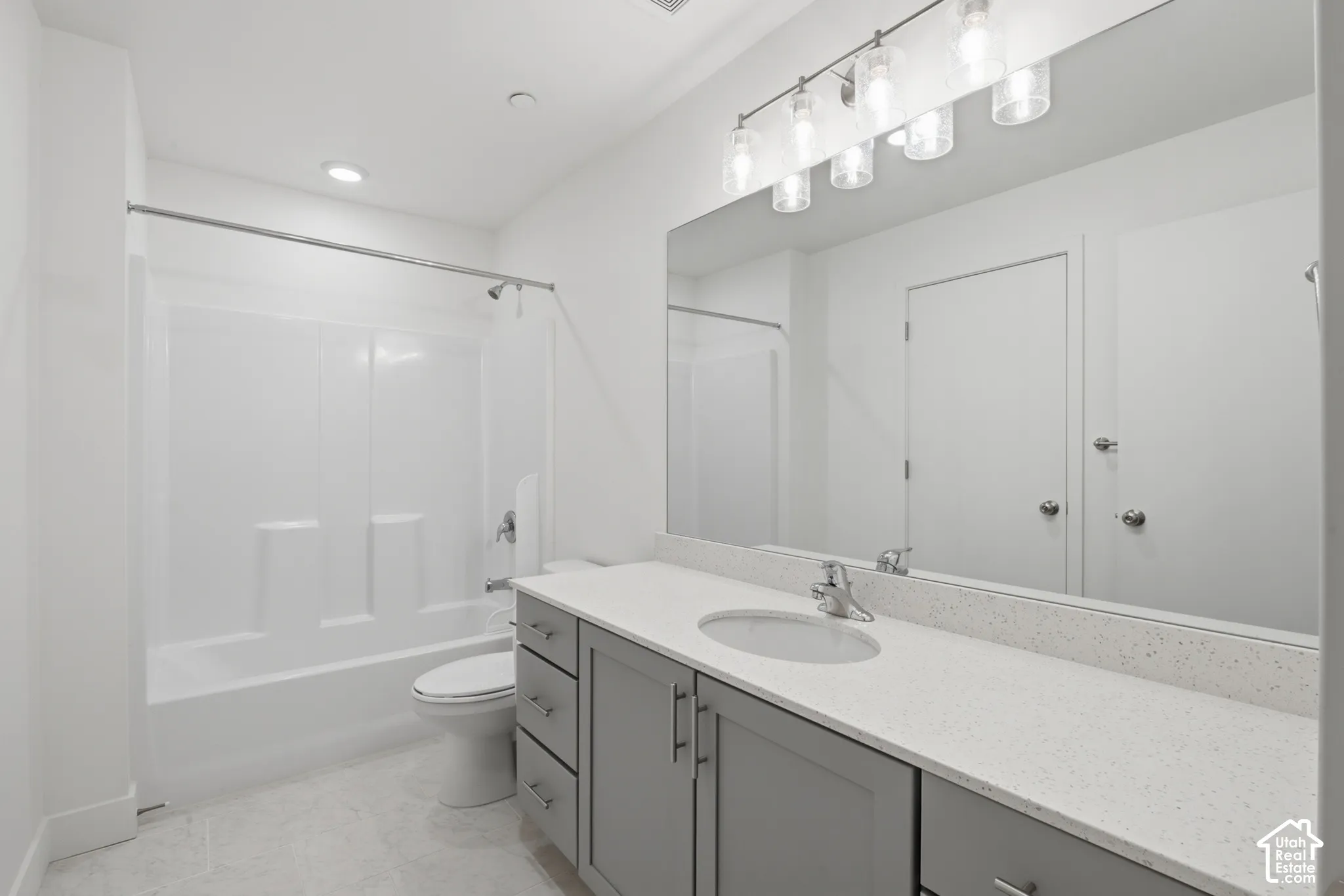 Second ensuite bathroom featuring a single vanity with white quartz countertops and a large mirror