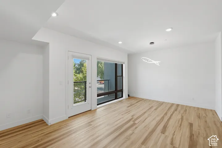 Spacious room with lots of natural light, and a contemporary dining chandalier