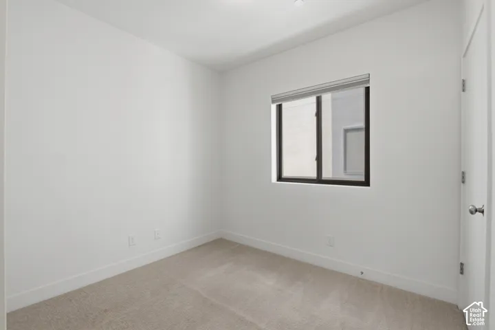 Bedroom on the main level featuring a sliding barn door - also makes a great office space!